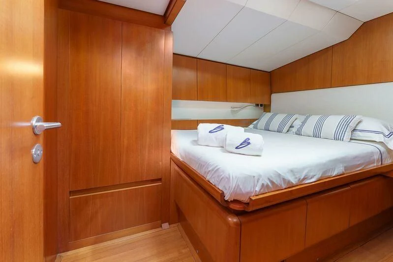 a room with a bed and a closet aboard BOMBARDA Yacht for Sale