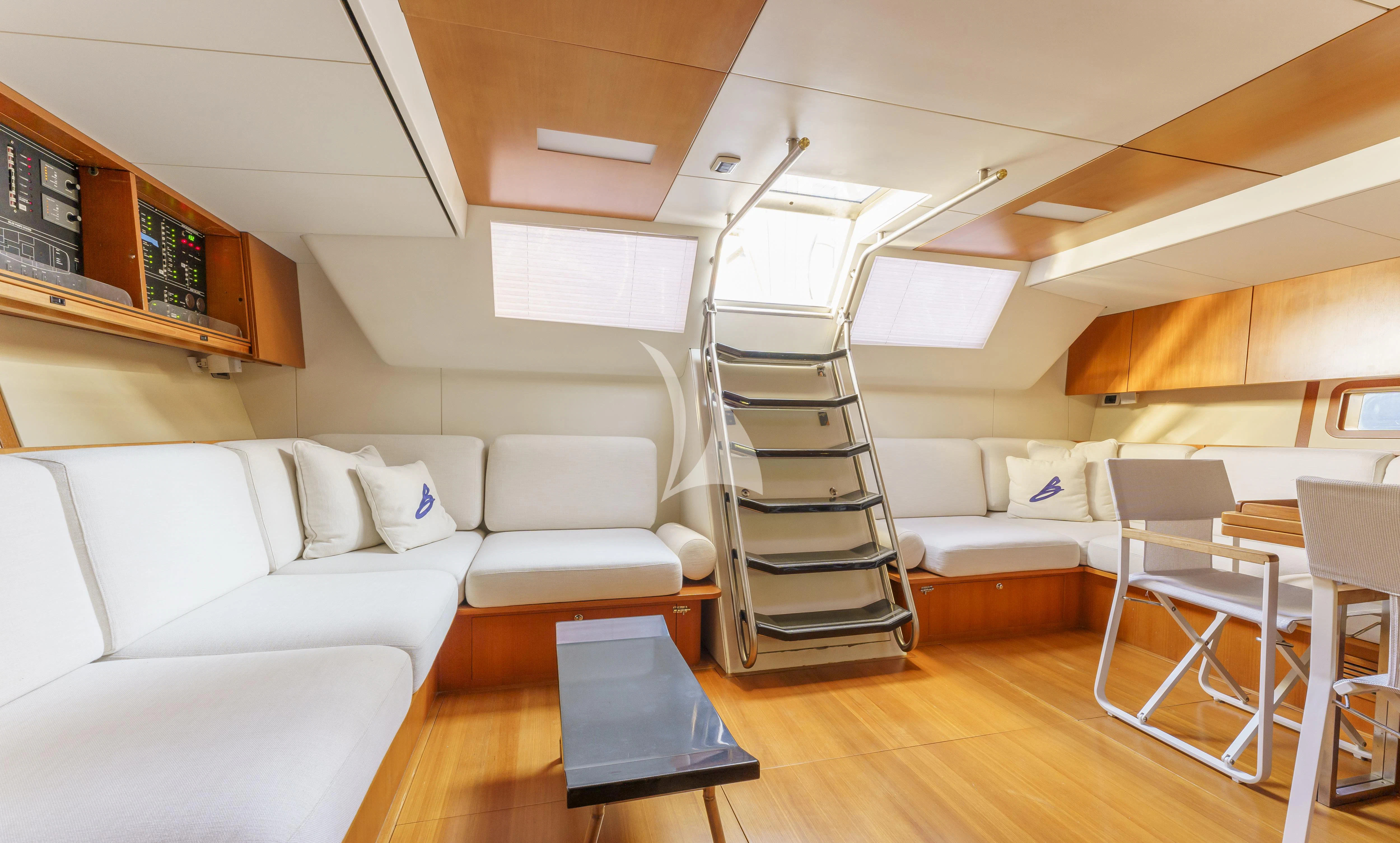 a room with a staircase and a couch aboard BOMBARDA Yacht for Sale