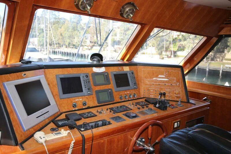 a wooden desk with a television and electronics on it aboard SALT II Yacht for Sale