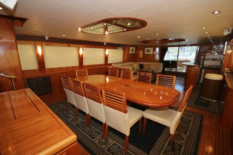 a restaurant with tables and chairs aboard SALT II Yacht for Sale