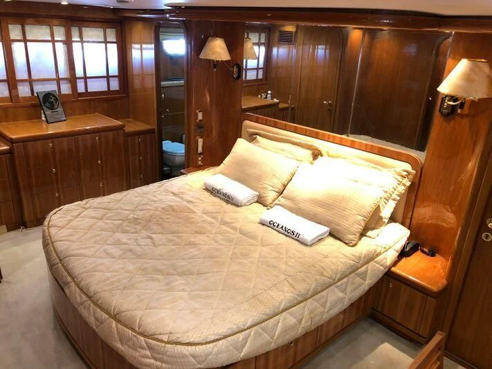 a bed with a book on it aboard SALT II Yacht for Sale