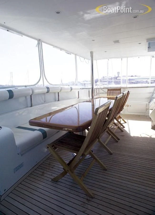 a wooden boat on a deck aboard SALT II Yacht for Sale