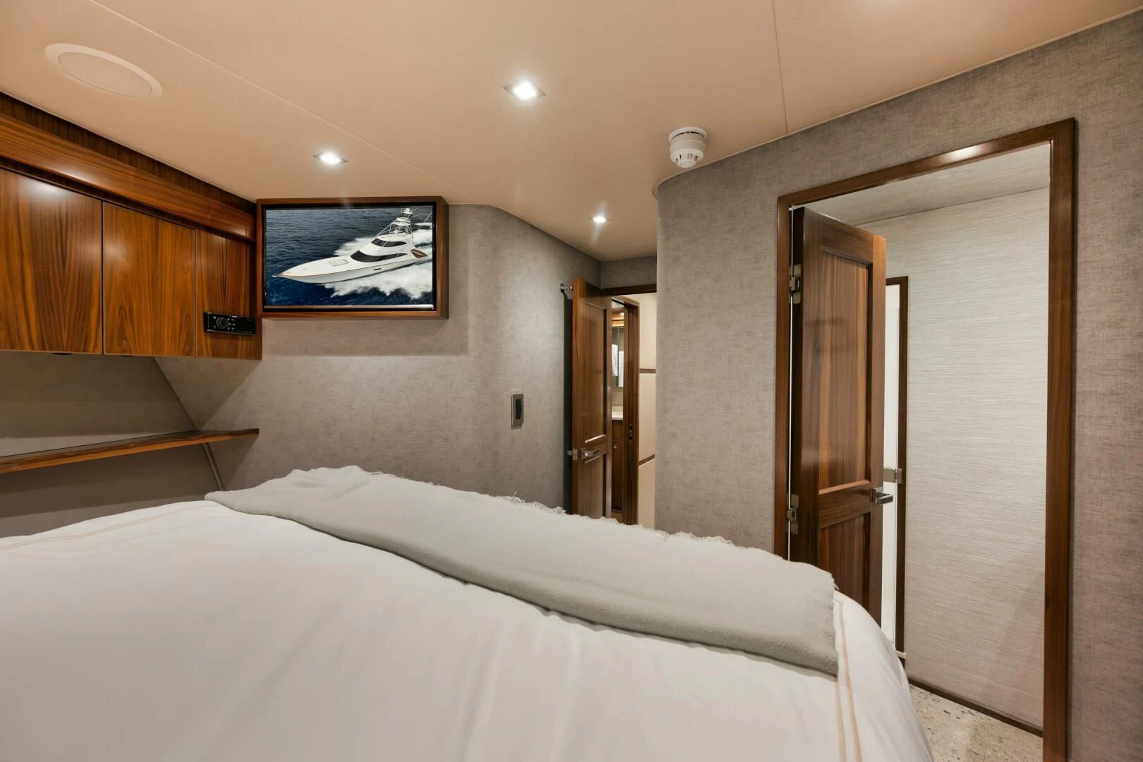 a hotel room with a bed and a television aboard TEUSEAS Yacht for Sale