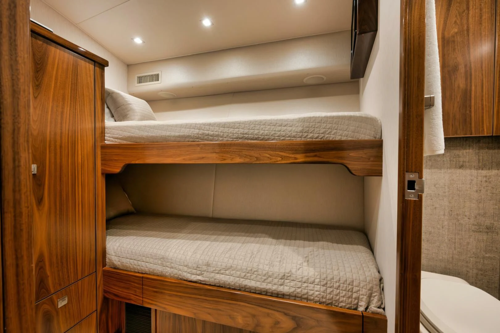 a bed with a wood headboard aboard TEUSEAS Yacht for Sale