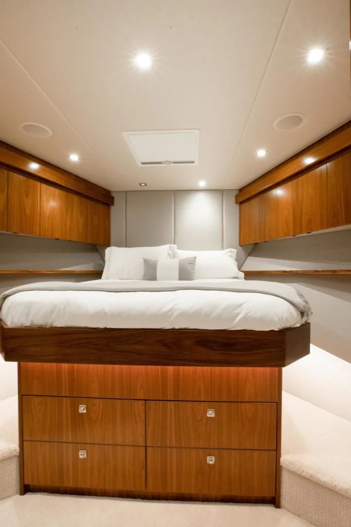 a room with wooden cabinets and a bed aboard TEUSEAS Yacht for Sale