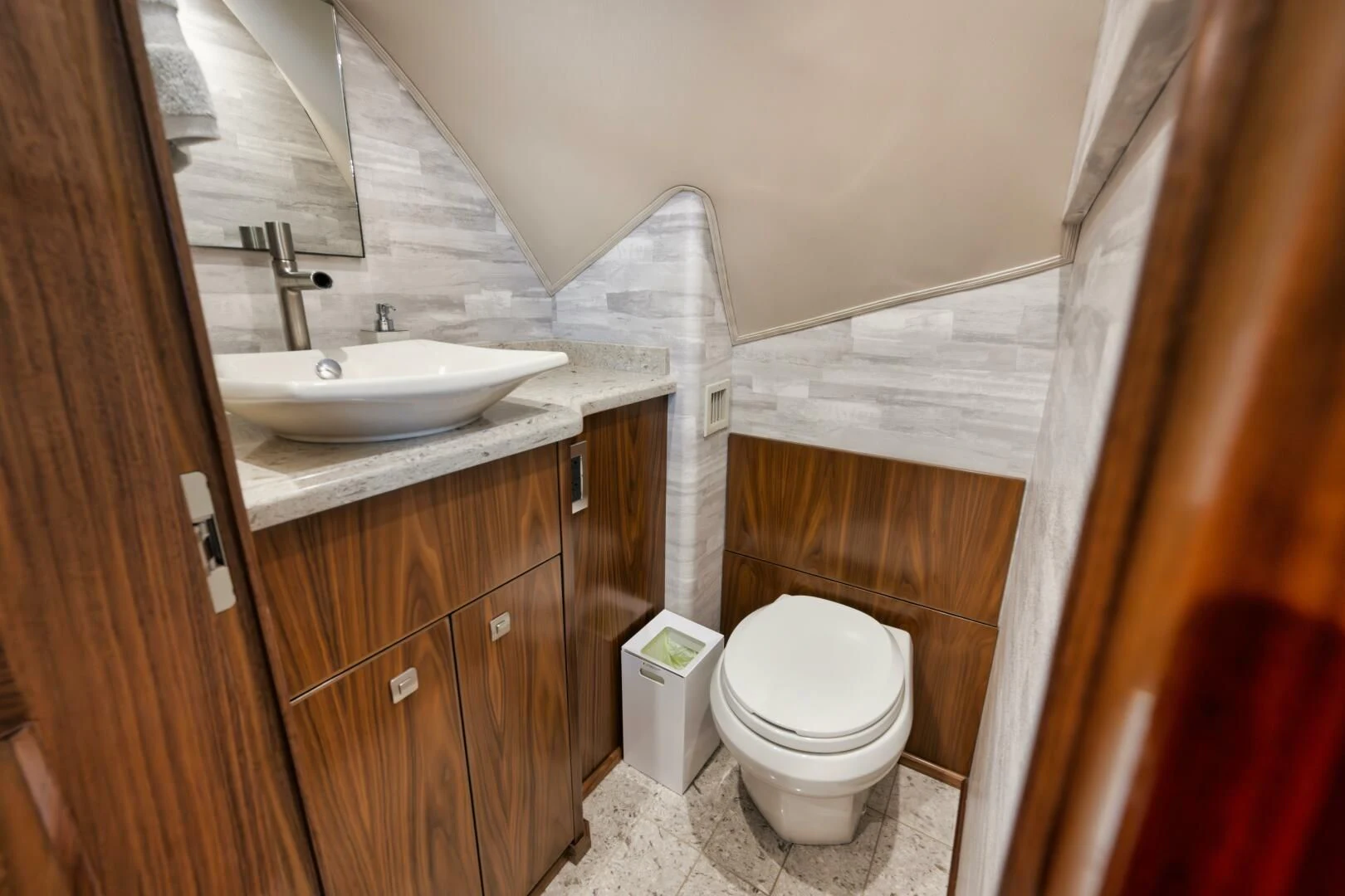 a bathroom with a sink toilet and a mirror aboard TEUSEAS Yacht for Sale