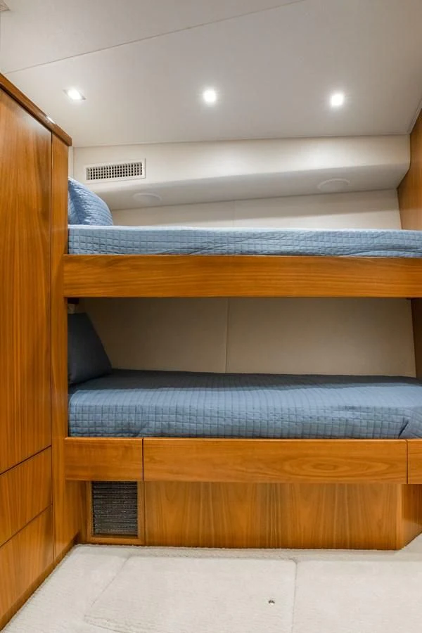 a bed with wooden drawers aboard TEUSEAS Yacht for Sale
