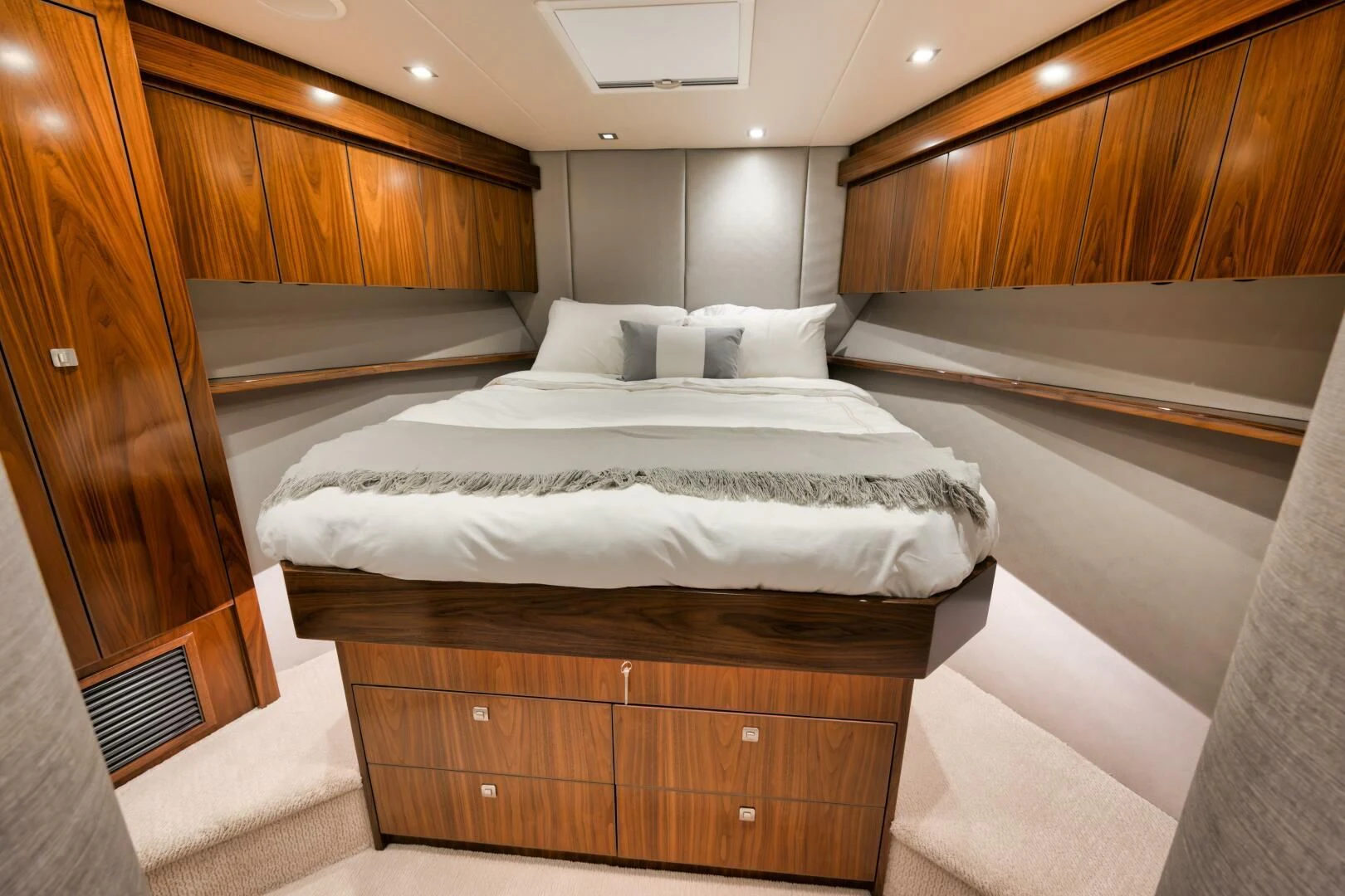 a room with a bed and a wood cabinet aboard TEUSEAS Yacht for Sale