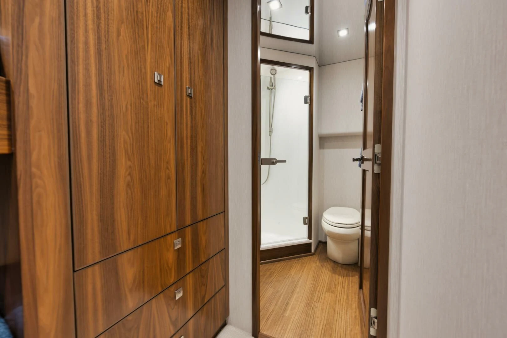 a bathroom with a toilet and a wooden door aboard TEUSEAS Yacht for Sale