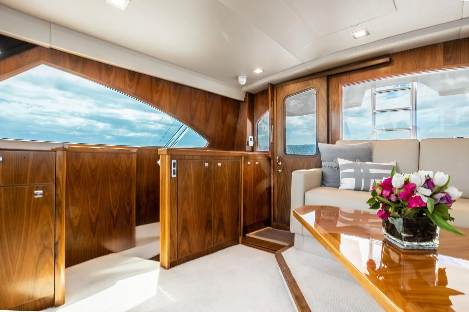 a room with a table and a couch aboard TEUSEAS Yacht for Sale