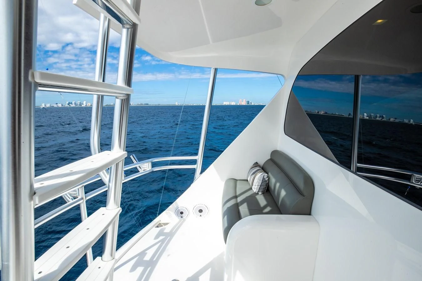 a boat with a seat and steering wheel on the deck aboard TEUSEAS Yacht for Sale