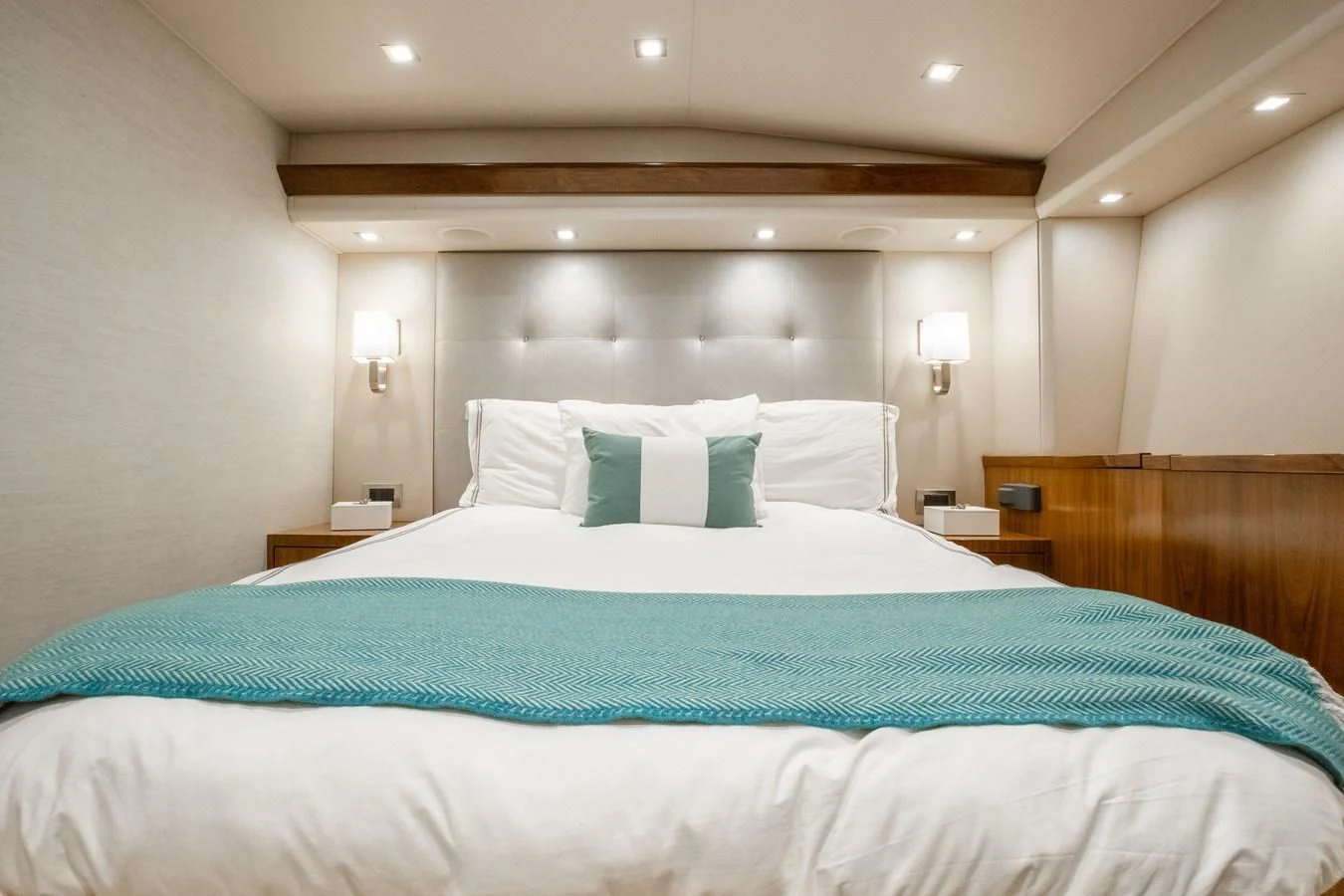 a bed with a blue comforter aboard TEUSEAS Yacht for Sale