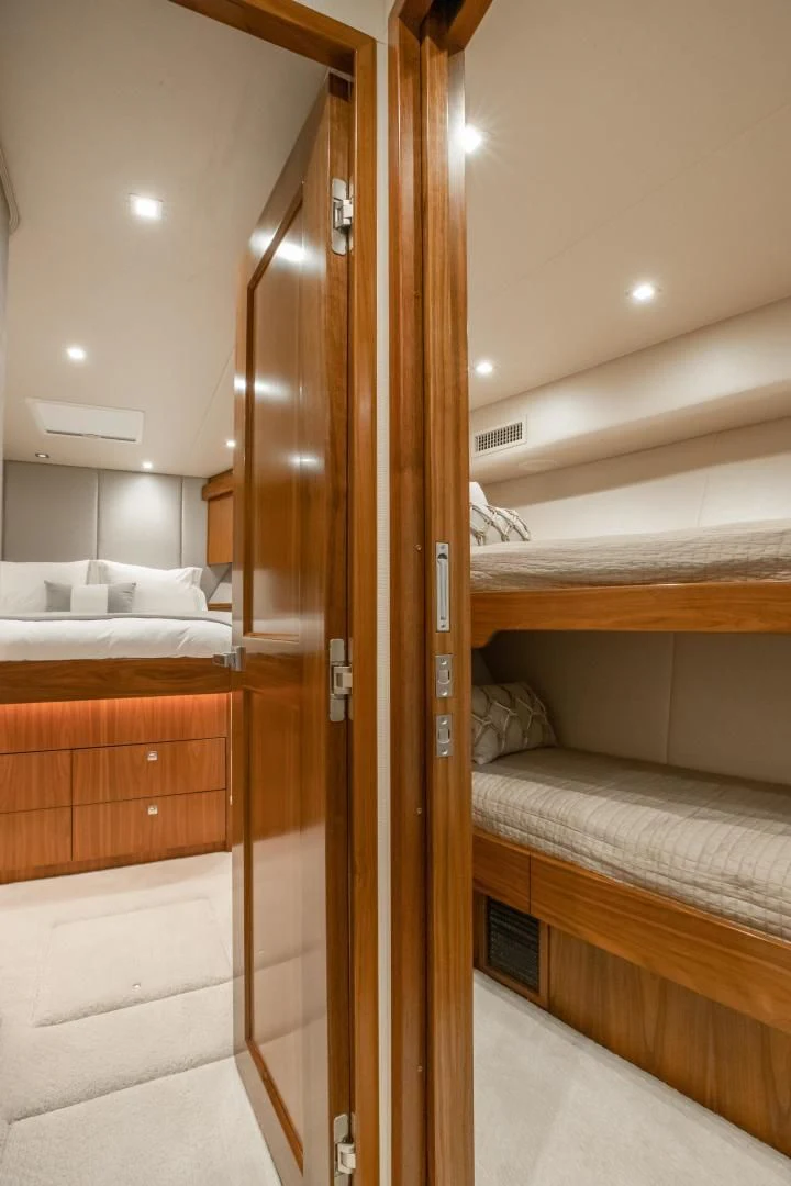 a room with a bed and a wood door aboard TEUSEAS Yacht for Sale