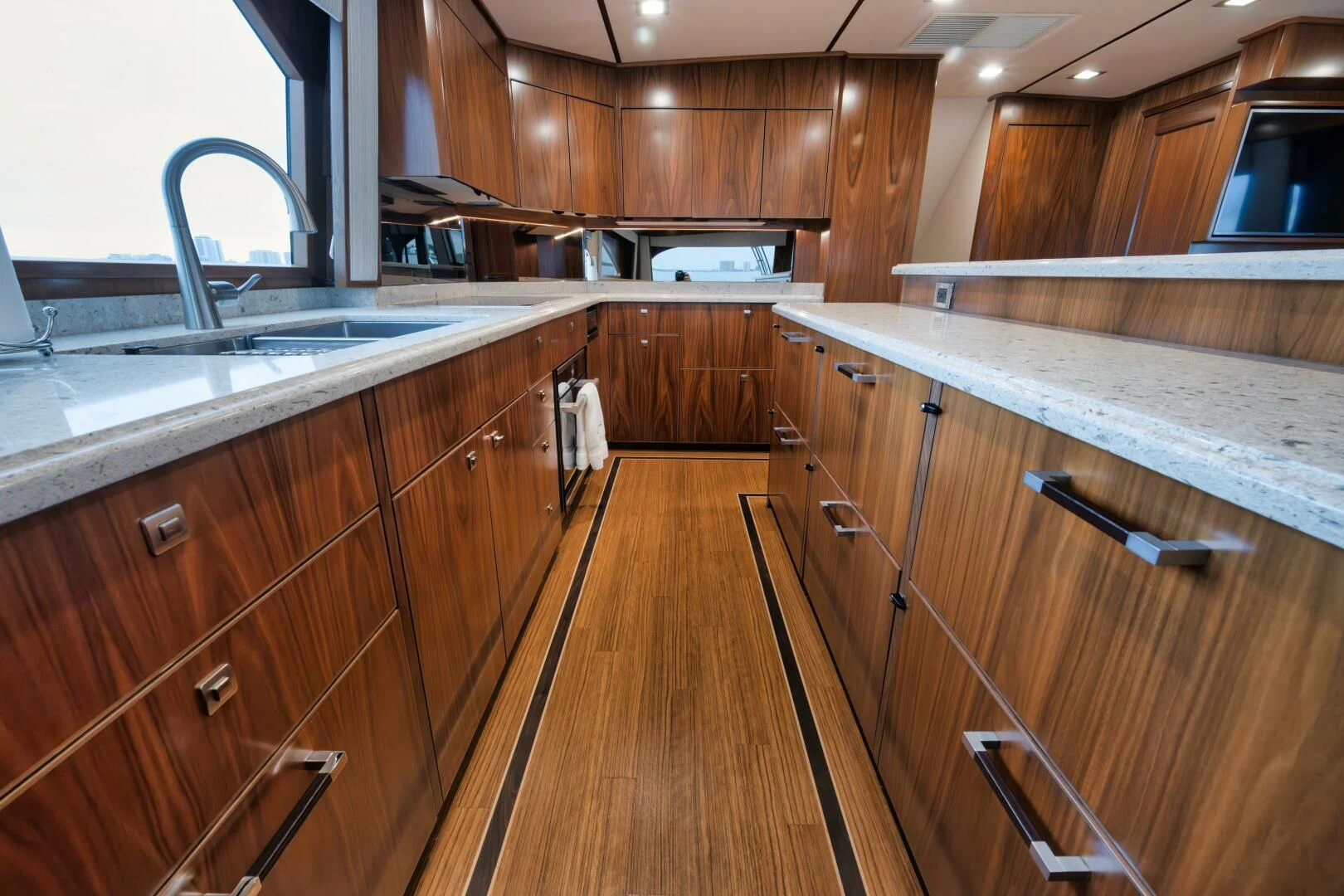 a kitchen with wooden cabinets aboard TEUSEAS Yacht for Sale