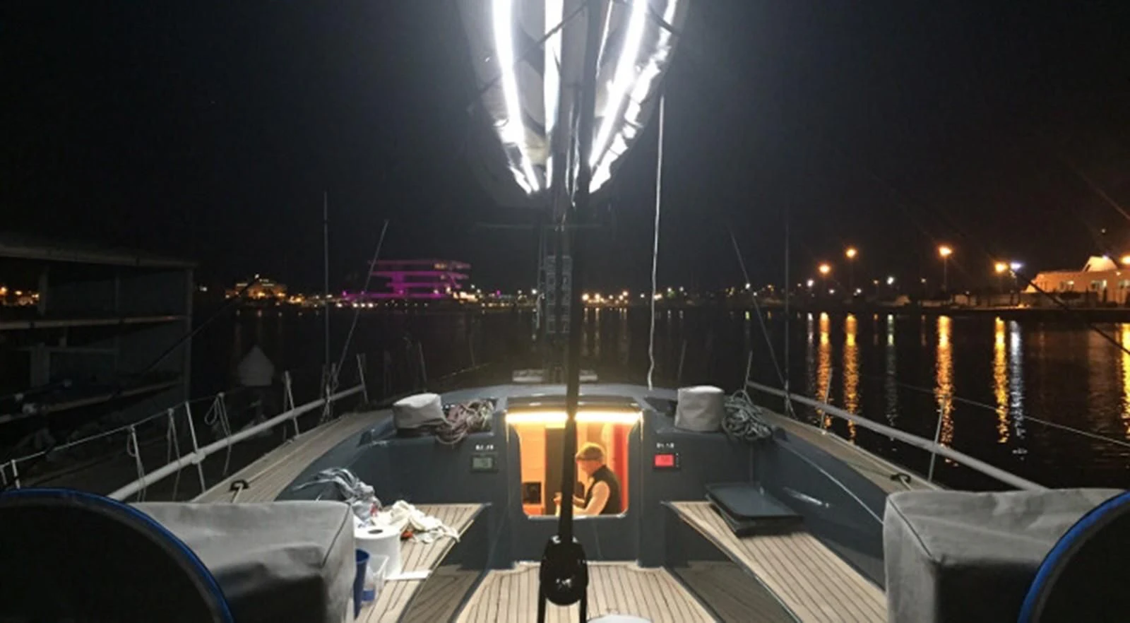 a person sitting in a boat at night aboard HIGH SPIRIT Yacht for Sale