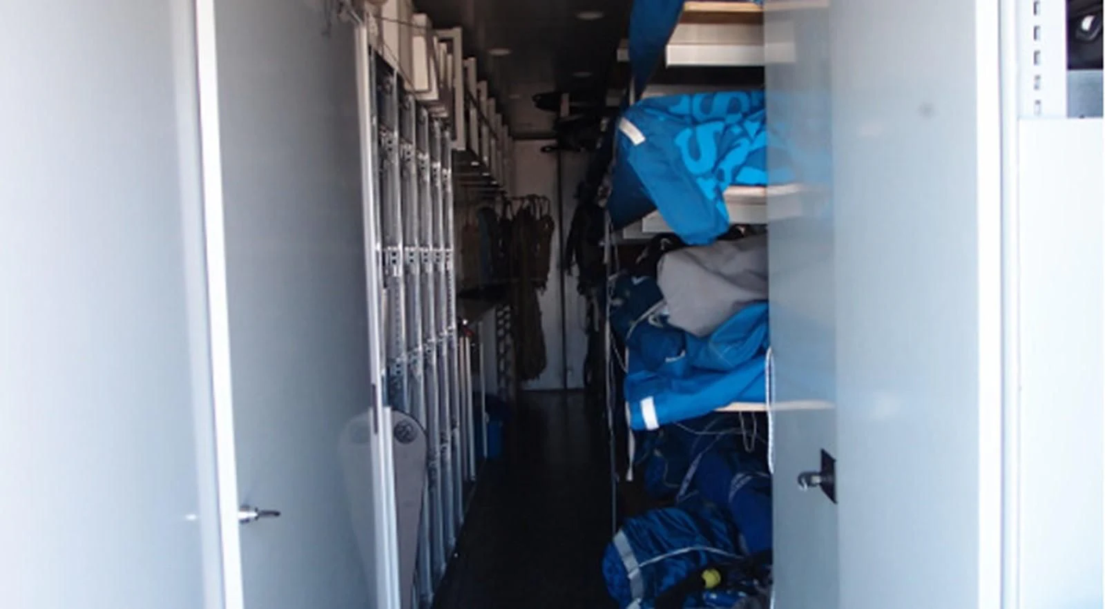a room with a blue jacket and a white door aboard HIGH SPIRIT Yacht for Sale