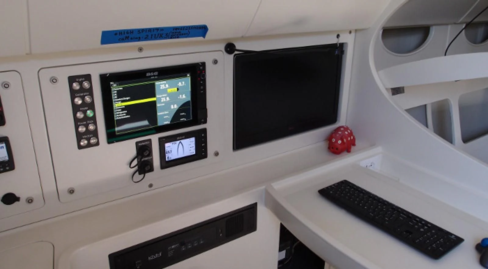 a white control panel with a keyboard and monitor aboard HIGH SPIRIT Yacht for Sale