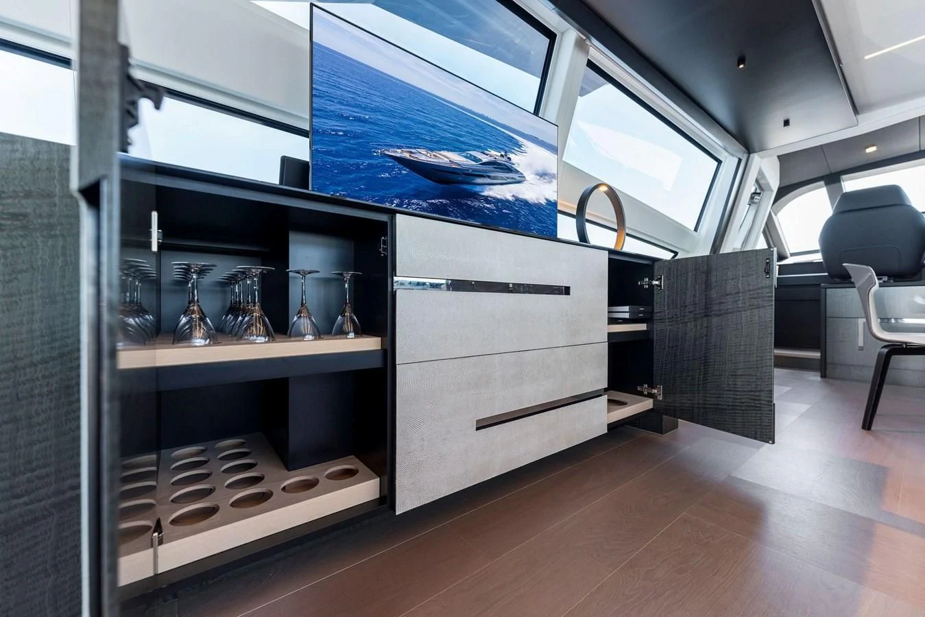 a room with a glass wall and a shelf with glassware aboard OUR TRADE Yacht for Sale
