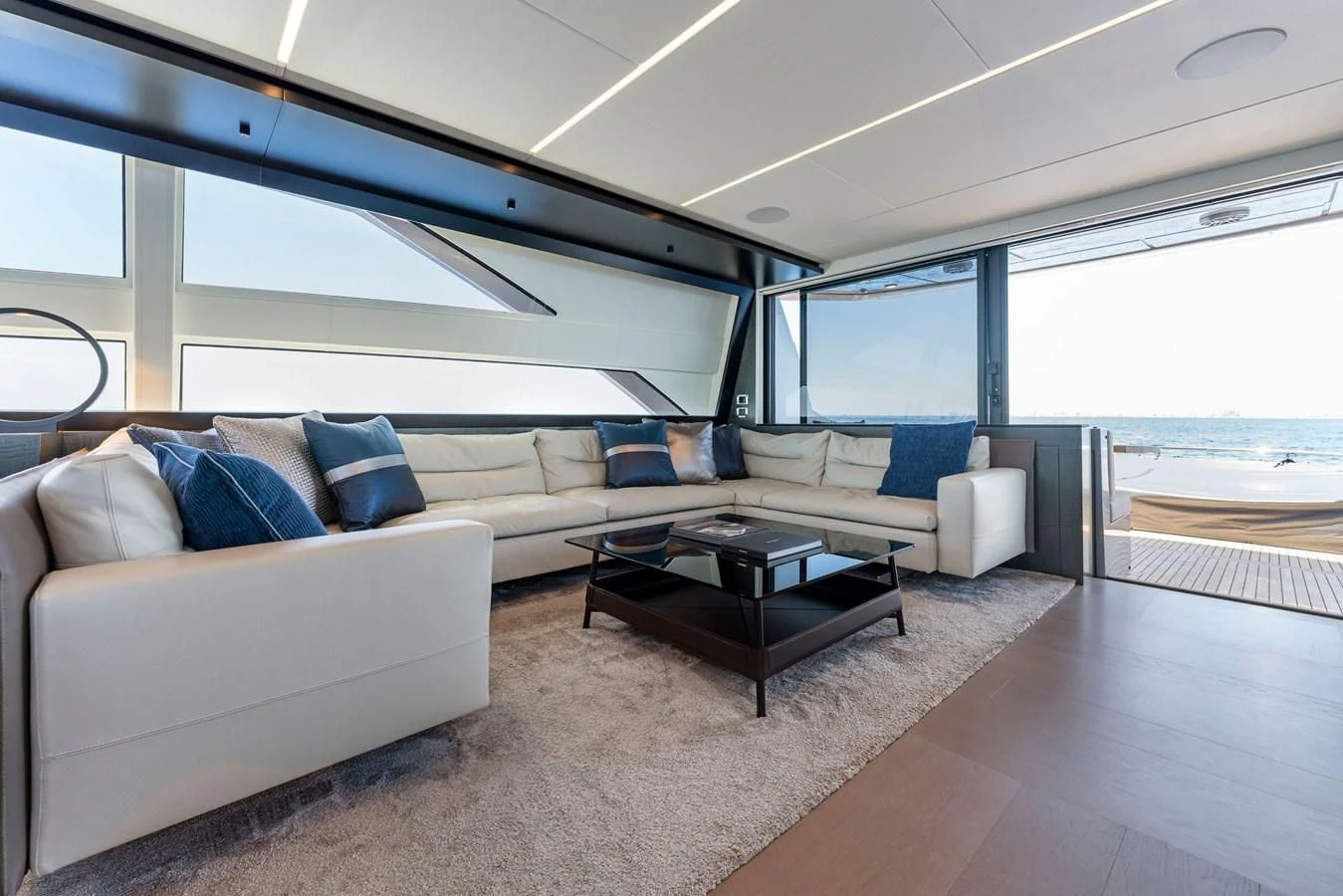 a living room with a couch and a table aboard OUR TRADE Yacht for Sale
