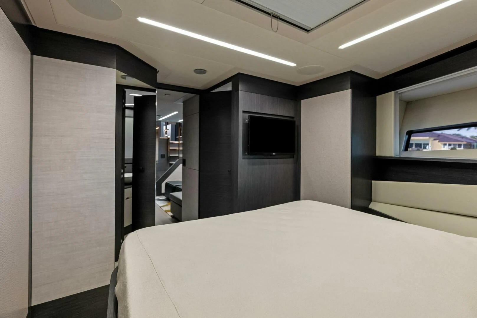a room with a bed and a television aboard OUR TRADE Yacht for Sale