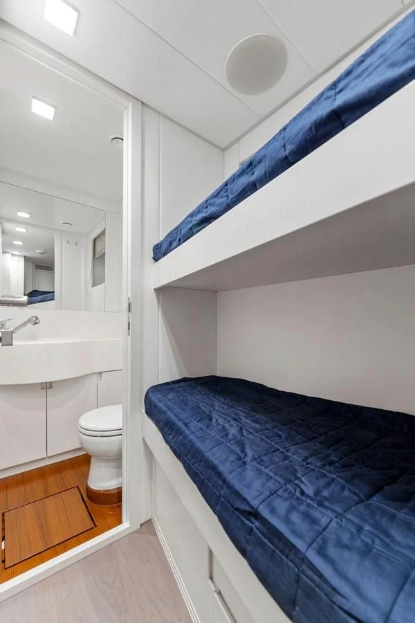 a bathroom with a blue bed sheet aboard OUR TRADE Yacht for Sale