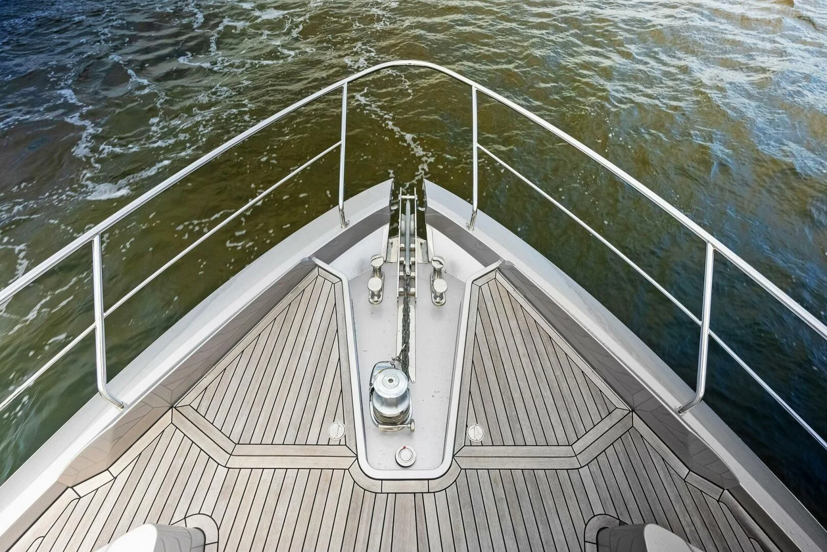a white boat on the water aboard OUR TRADE Yacht for Sale