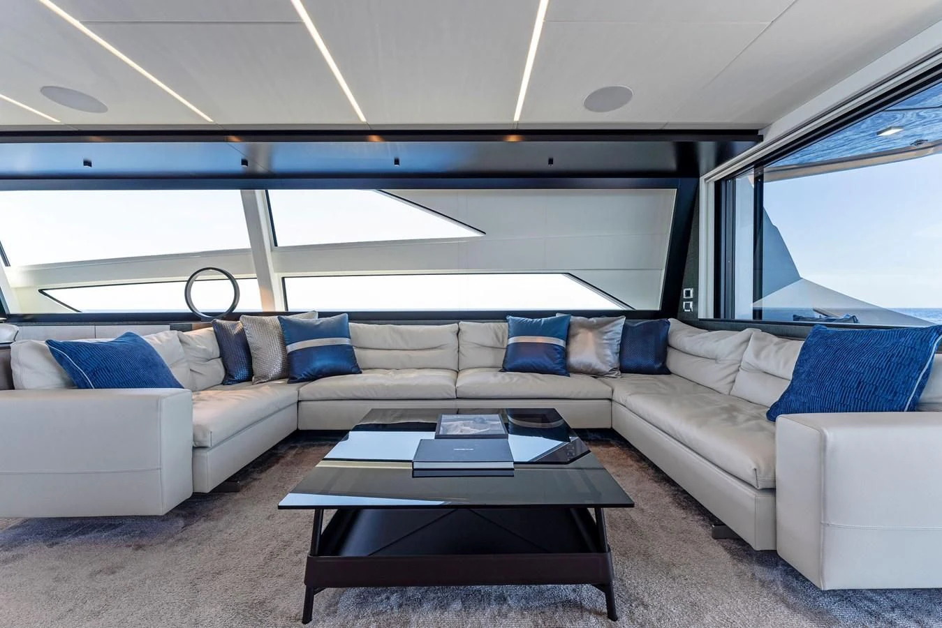 a living room with a couch and a coffee table aboard OUR TRADE Yacht for Sale