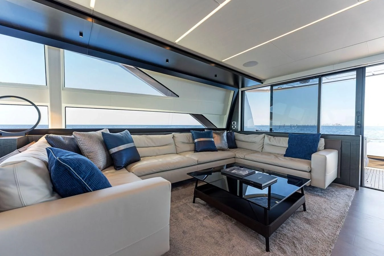 a living room with a couch and a coffee table aboard OUR TRADE Yacht for Sale