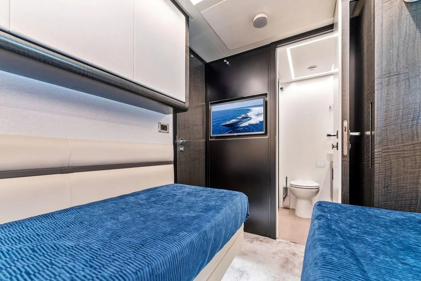 a bedroom with a bed and a blue bed aboard OUR TRADE Yacht for Sale
