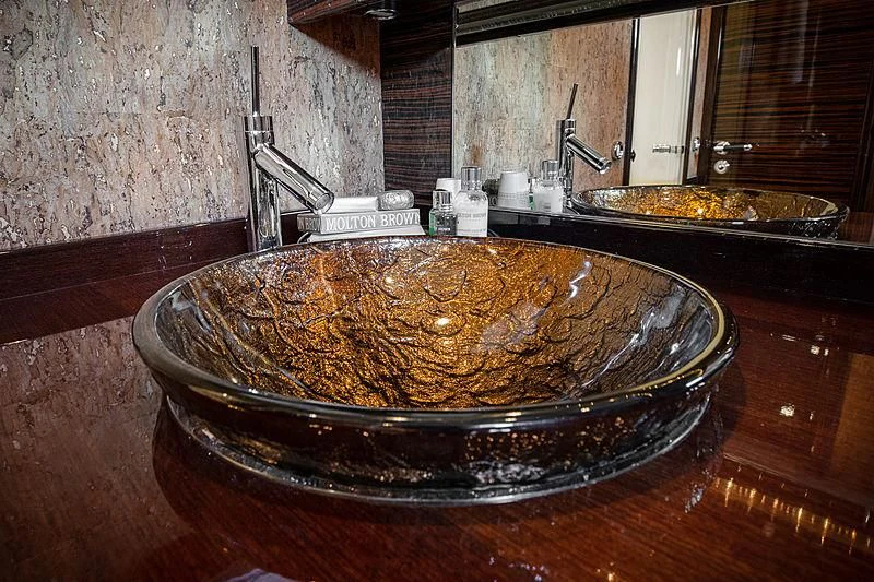 a large round metal dish with food on a wooden surface aboard GO Yacht for Sale