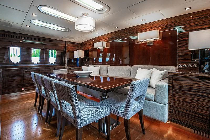 a room with a table and chairs aboard GO Yacht for Sale