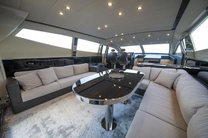 a room with a table and couches aboard MYSTERE Yacht for Sale
