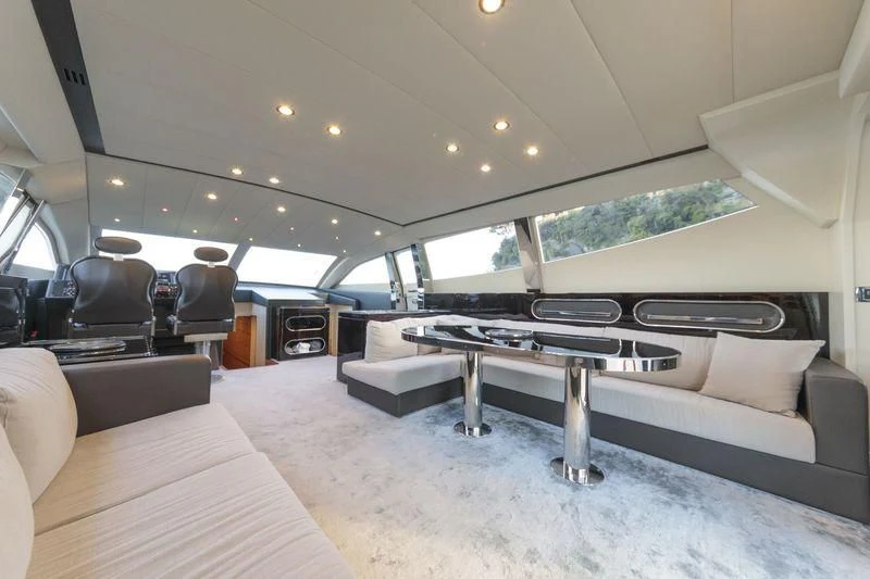 a large living room with a large table and couches aboard MYSTERE Yacht for Sale