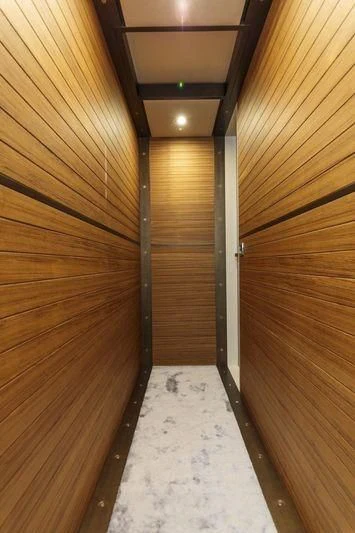 a wood wall with a light aboard MYSTERE Yacht for Sale