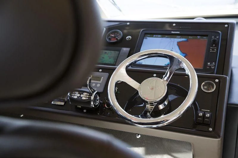 a steering wheel and dashboard of a car aboard MYSTERE Yacht for Sale