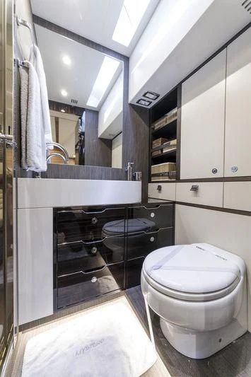 a bathroom with a toilet and a sink aboard MYSTERE Yacht for Sale