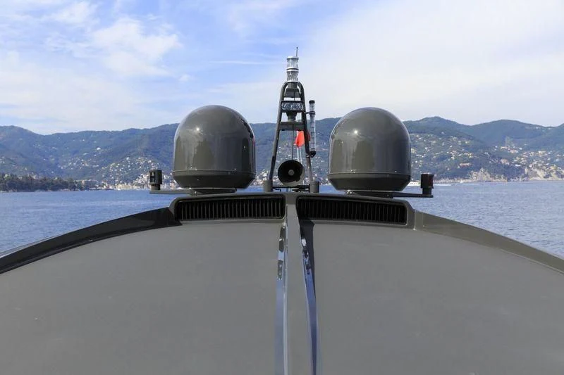 a large grey ship on a body of water aboard MYSTERE Yacht for Sale