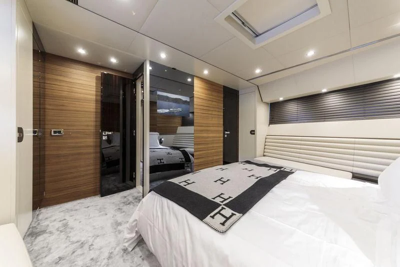 a bedroom with a bed and a desk aboard MYSTERE Yacht for Sale