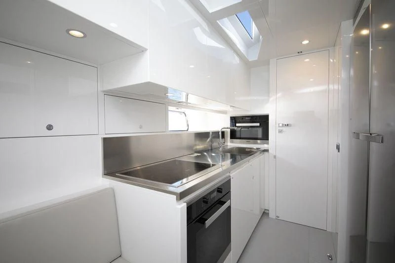 a kitchen with white cabinets aboard MYSTERE Yacht for Sale