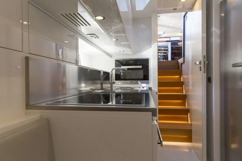 a kitchen with a sink and a staircase aboard MYSTERE Yacht for Sale