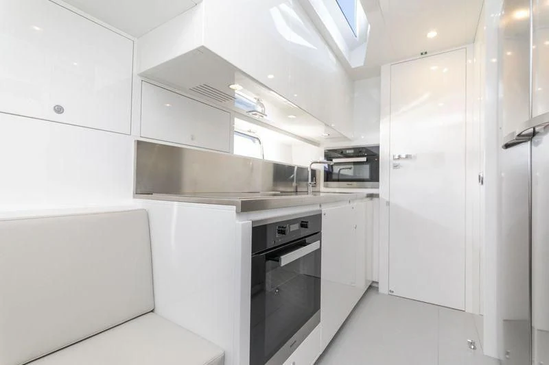 a kitchen with white cabinets aboard MYSTERE Yacht for Sale
