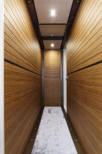 a wood wall with a long wood staircase aboard MYSTERE Yacht for Sale