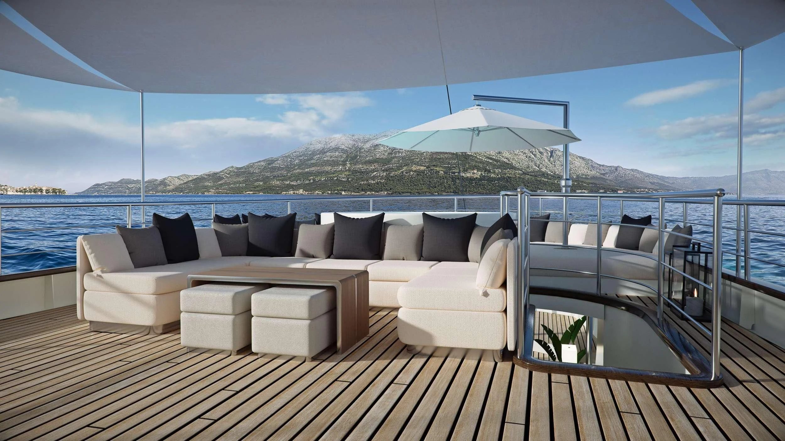 a large white couch on a deck overlooking a large body of water aboard MAIA Yacht for Sale