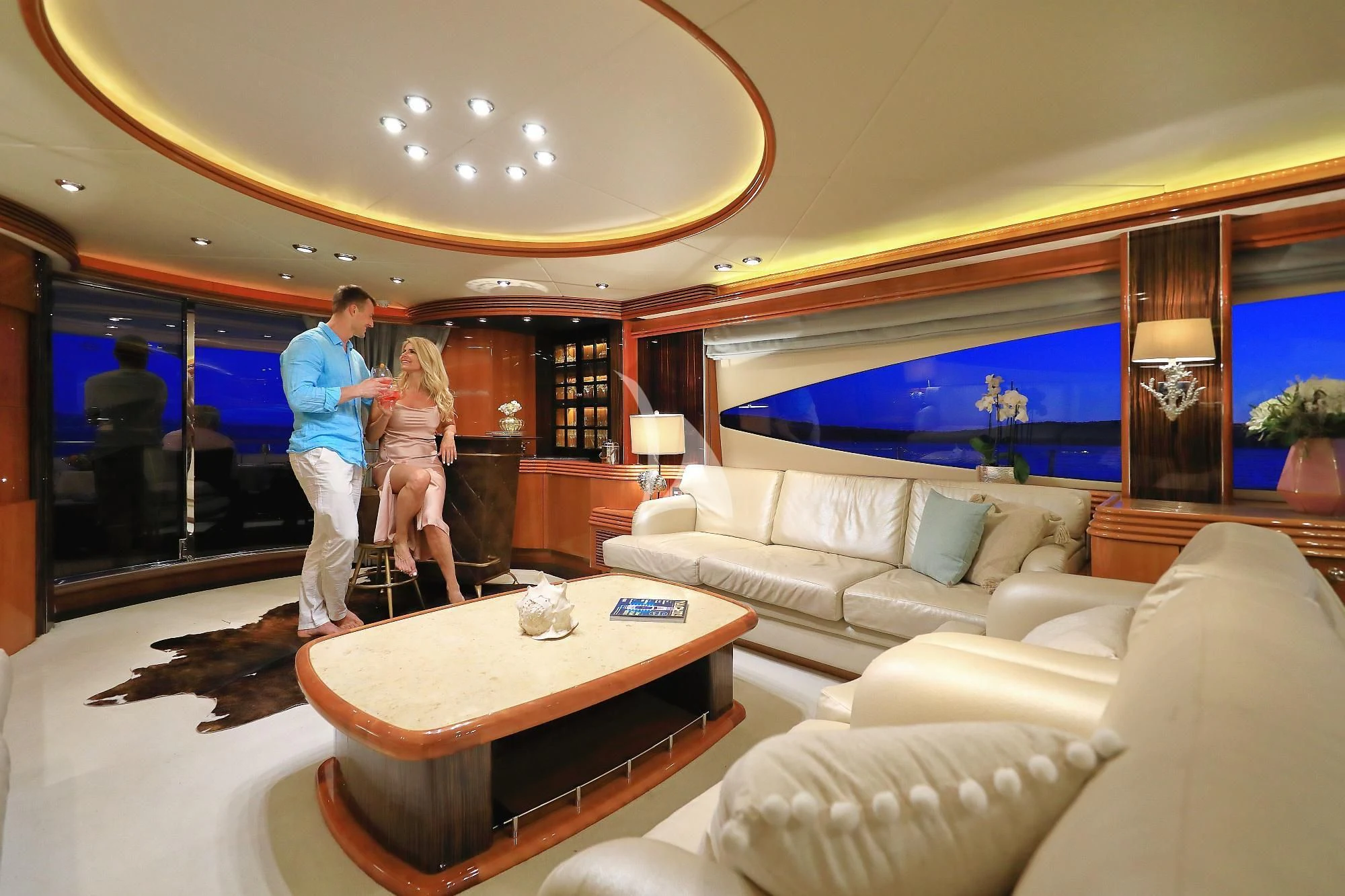 a couple of people in a living room aboard BABY I Yacht for Sale