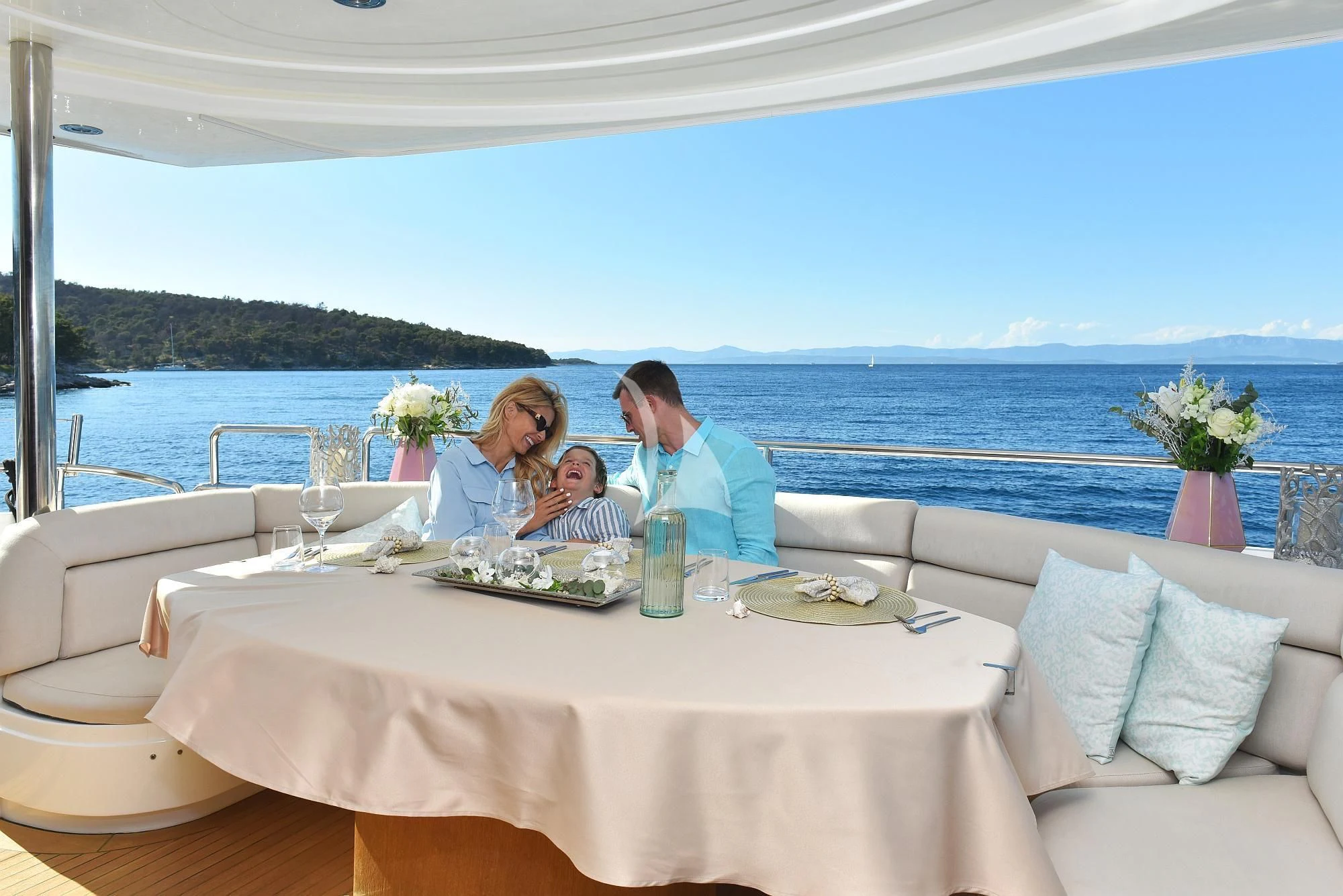 a group of people sitting at a table on a boat aboard BABY I Yacht for Sale