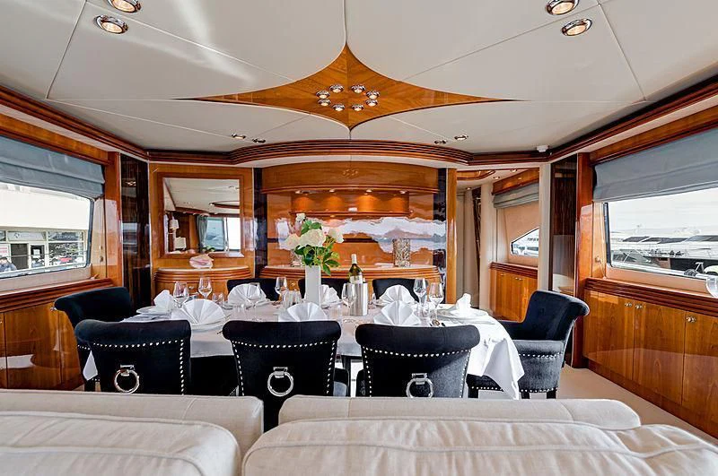a dining room with a table set aboard BABY I Yacht for Sale