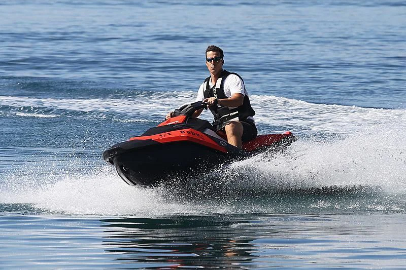 a man riding a jet ski aboard BABY I Yacht for Sale