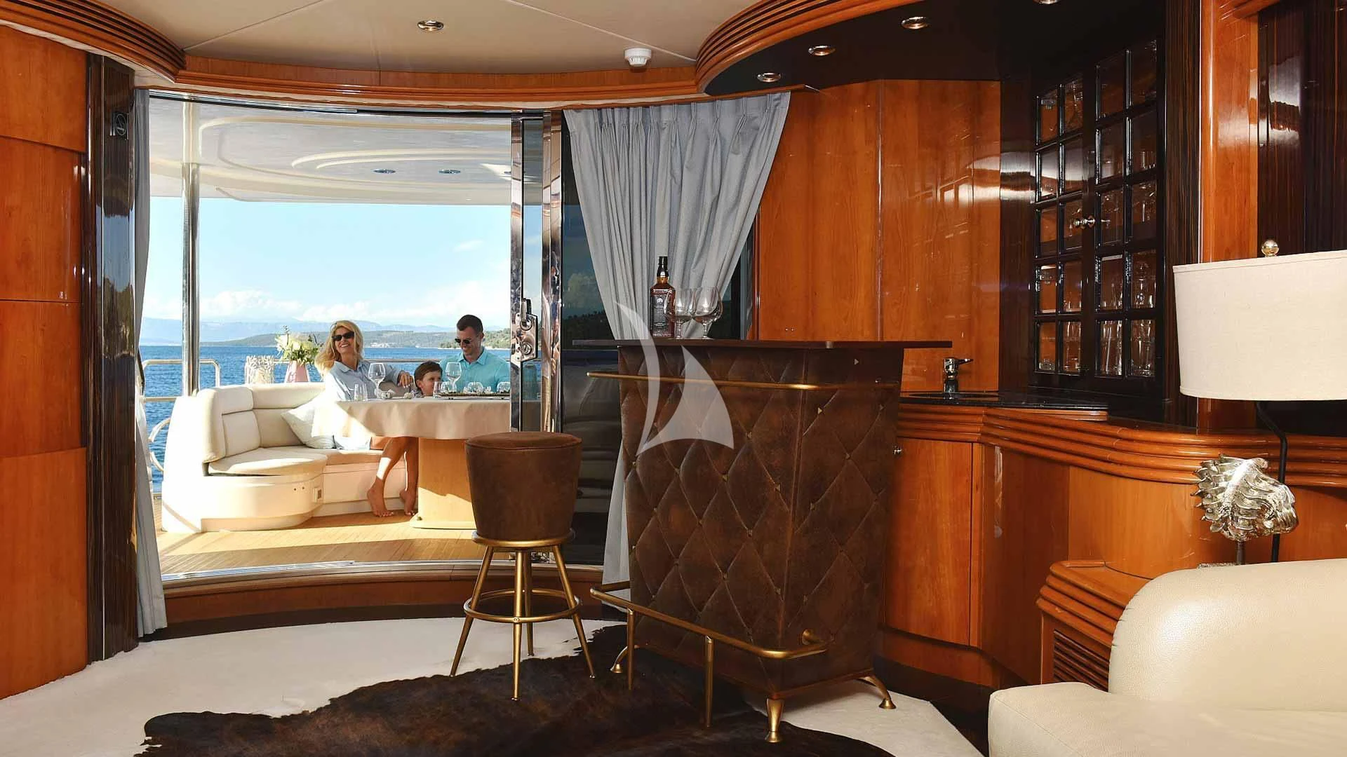 a room with a fireplace and a couple of people sitting in the window aboard BABY I Yacht for Sale