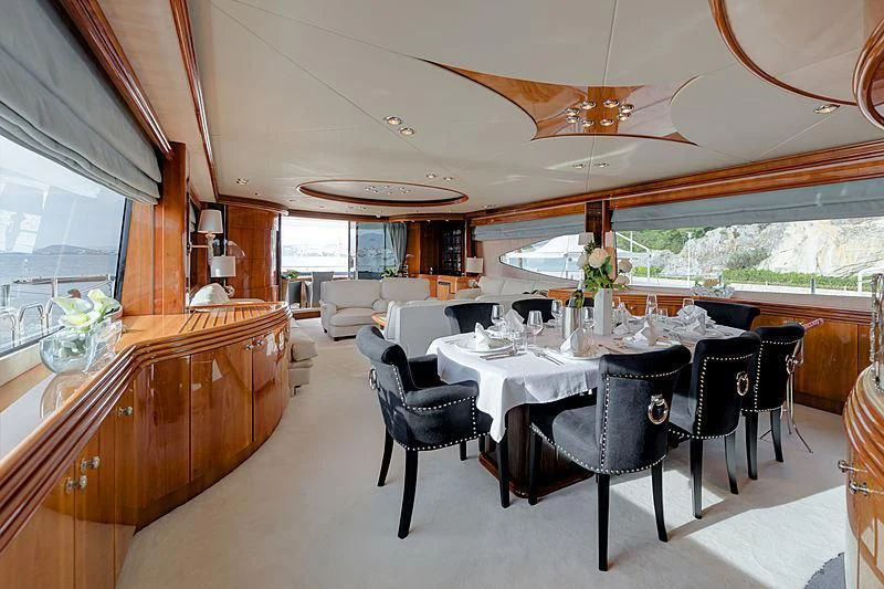 a dining room with a large window aboard BABY I Yacht for Sale
