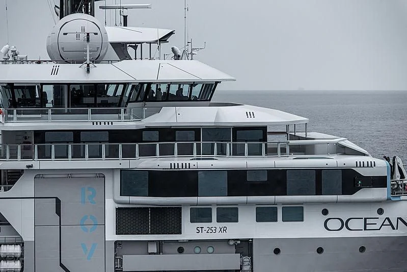 a large white boat with a satellite dish on top aboard OCEANXPLORER 1 Yacht for Sale